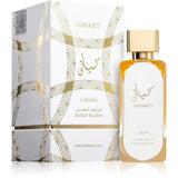 Флаконът и кутията на Lattafa Hayaati Gold Elixir EDP 100 мл, показани заедно с леко отражение.